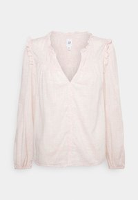 Lange mouw, lichtroze blouse met een gestructureerd ruitpatroon, gerimpelde accenten op de schouders en een V-hals. Zachte, lichte stof.