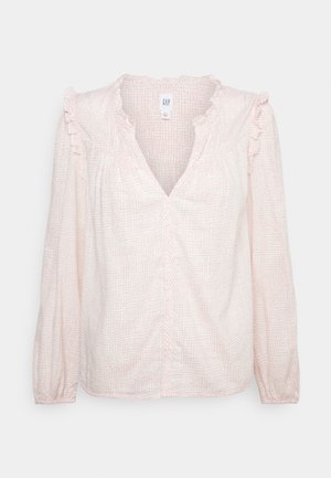 Blusa a maniche lunghe di colore rosa chiaro con un motivo a griglia testurizzato, dettagli arricciati sulle spalle e scollatura a V. Tessuto morbido e leggero.