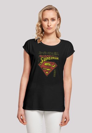 Black short-sleeve t-shirt featuring a distressed Superman logo in red and yellow, with Japanese text above and below the design.