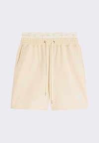 Shorts en coton beige avec taille élastique, cordon de serrage et poches latérales. Présente un logo brodé sur l'ourlet et un tissu texturé.