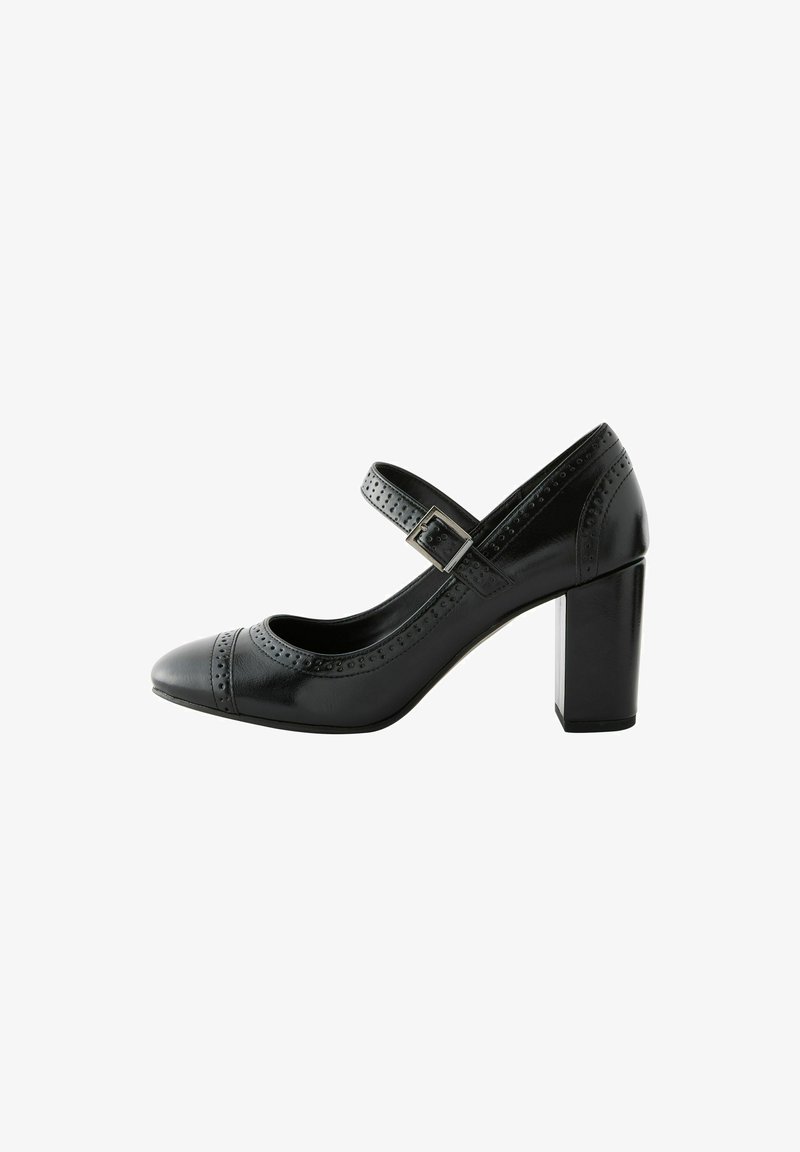 Black leather high heel shoe with a rounded toe, strap with silver buckle, brogue detailing along the edges, and a chunky heel.