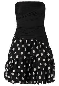 Robe noire sans bretelles avec corsage froncé et jupe superposée présentant de grands pois blancs sur un tissu transparent.