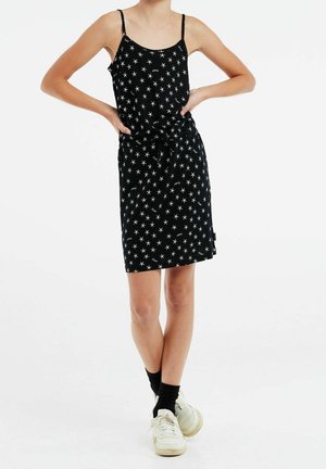 Abito nero con pattern di stelle bianche, spalline sottili e cintura in vita. Realizzato in tessuto morbido, design al ginocchio, adatto per un look casual.