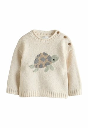 Hellbeiger Pullover aus strukturiertem Stoff mit einem Schildkrötenmotiv in Braun und Grün. Mit einer Dreiknopfleiste auf der Schulter.