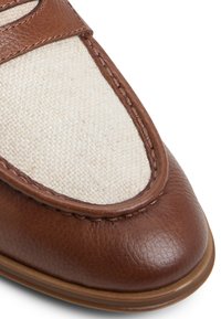 Brown leather shoe with a textured cream fabric panel; rounded toe, stitched detailing, and a contrasting brown trim.