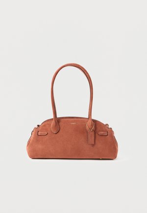 Small brown suede handbag with dual shoulder straps and a Coach logo tag hanging near the handle.