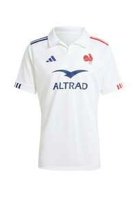 Hvid kortærmet polo skjorte med krave, med røde og blå detaljer på ærmerne. Inkluderer blåt logo og rød kyllingemblem.