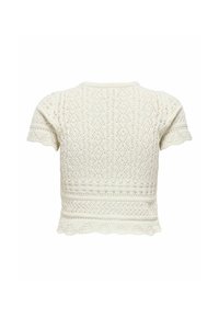 Haut blanc en crochet à manches courtes avec des motifs complexes en forme de losange et de zigzag et un ourlet festonné.