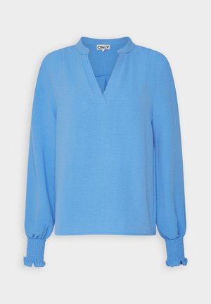 Light blue long-sleeve blouse made of soft fabric, featuring a V-neckline and smocked cuffs with a relaxed fit design.