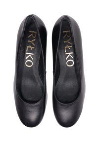 Zwarte platte leren schoenen met een gladde afwerking. Voorzien van een ronde neus en subtiele gouden merkopdruk aan de binnenkant. Geen zichtbare metalen onderdelen of accenten.