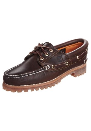 Dark brown leather boat shoe with white stitching, lace-up front, padded collar, and rubber sole with deep treads.