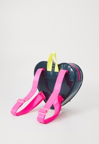 Heart-shaped backpack with a glossy navy exterior, pink straps, and a yellow top handle. Features a zip closure and shiny texture.
