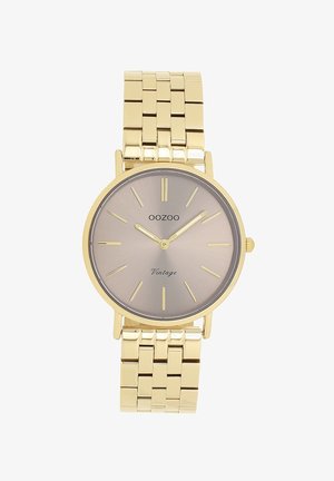 Montre en métal doré avec un cadran argent-gris en soleil, des marqueurs d'heure fins et un bracelet lisse. Elle présente un boîtier rond et un design minimaliste.