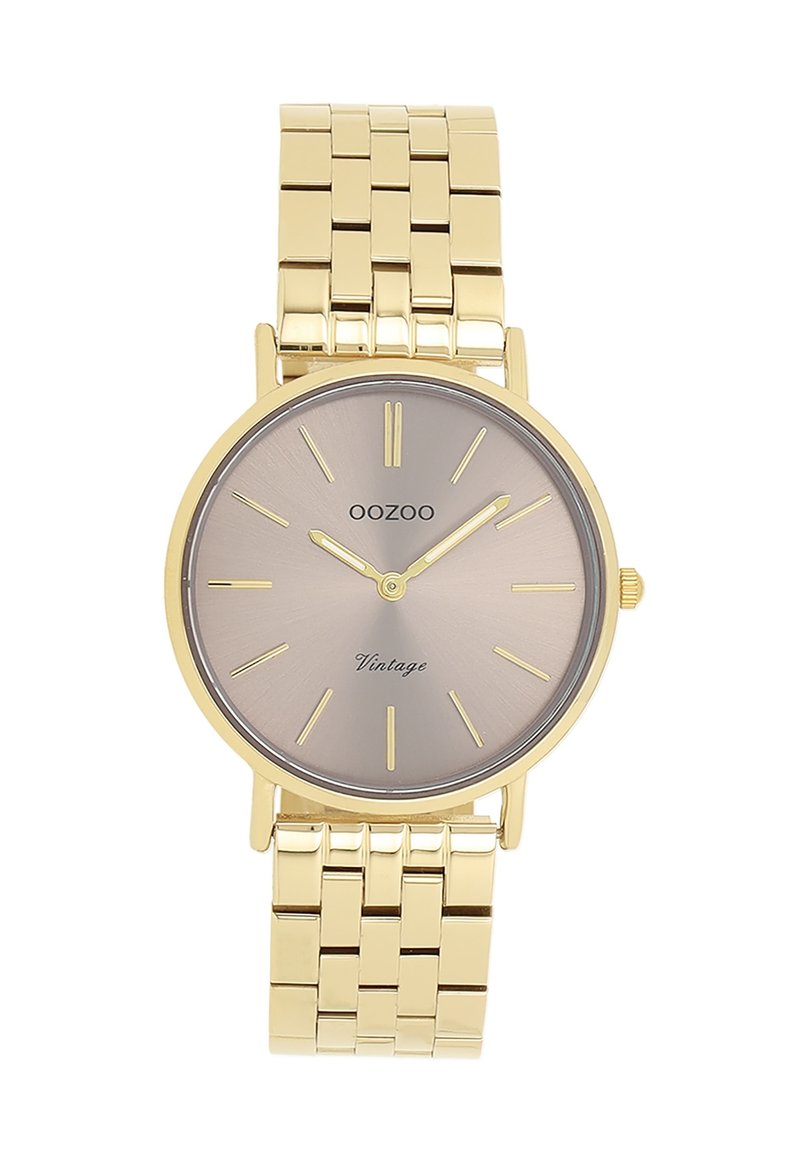 Montre en métal doré avec un cadran argent-gris en soleil, des marqueurs d'heure fins et un bracelet lisse. Elle présente un boîtier rond et un design minimaliste.