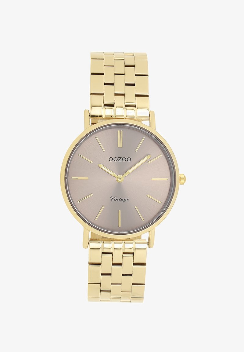 Montre en métal doré avec un cadran argent-gris en soleil, des marqueurs d'heure fins et un bracelet lisse. Elle présente un boîtier rond et un design minimaliste.