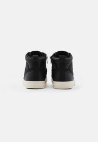 Black high-top sneakers with a smooth leather finish, textured fabric accents, and white rubber soles. Features zippers at the back.