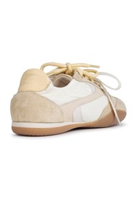 Lace-up sneaker featuring a combination of off-white leather and beige suede, rounded shape, and a textured sole. Accents include contrasting laces.
