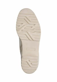 Semelle de chaussure de couleur claire avec un motif de semelle texturée, comprenant des rainures et des crêtes pour une meilleure adhérence ; marquée "Marco Tozzi" et taille 37.