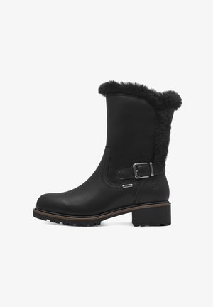 Bottines en cuir noir avec bordure en fausse fourrure, boucle sur le côté, semelle texturée et bout rond. Design robuste avec un talon carré.