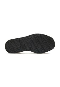 Black rubber shoe sole with a textured, patterned surface for grip. Features a central groove and branding detail embedded in the sole.
