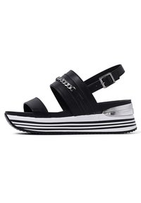 Sandali neri con plateau, dotati di due cinturini anteriori e una cinghia della caviglia regolabile. Caratterizzati da dettagli in catena argentata e una suola a zeppa a righe.