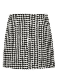 Short black and white houndstooth skirt made of textured fabric, featuring a straight shape and subtle fringe detailing along the hem.
