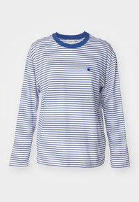 Långärmad randig skjorta i vitt och blått. Har en rund halsringning och en liten blå logotyp på vänster bröst. Tillverkad av lätt tyg.