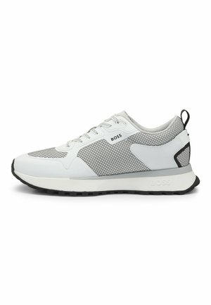 White and grey athletic shoe featuring mesh upper, rubber sole, and contrasting black accents. Laces and branding visible on the side.
