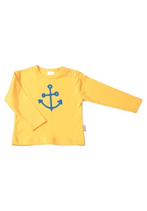 Yellow long-sleeve t-shirt with a blue anchor design on the front, made of soft fabric, featuring a snap closure on the shoulder.