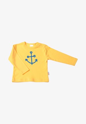 Gelbes Langarmshirt mit einem blauen Ankerdesign auf der Vorderseite, aus weichem Stoff gefertigt, mit Druckknopfverschluss an der Schulter.