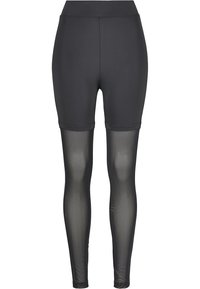 Svarta tights med en solid övre del och genomskinliga, texturerade nedre paneler. Elastisk midja för komfort och flexibilitet.