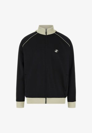Black zip-up jacket with a high collar, beige accents, and ribbed cuffs. Features a logo on the chest and side pockets. Soft texture.