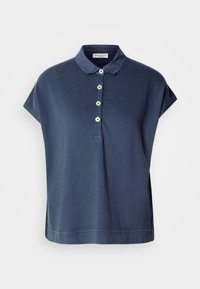 Polo bleu marine à manches courtes avec quatre boutons blancs et un col souple, coupe ample avec un ourlet droit.