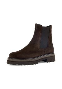 Bruine suede enkellaars met elastische panelen, ronde neus en een dikke, gestructureerde zool. Bevat een contrasterende afwerking langs de rand van de zool.