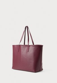 Burgundy tote bag made of textured leather with two long handles, featuring a geometric pattern on the surface and a top open design.