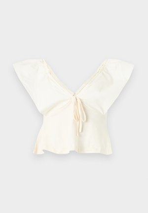 Off-white cropped blouse with wide flutter sleeves, deep V-neckline, and front tie detail.