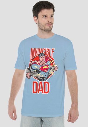 Man wearing light blue T-shirt with Superman graphic ripping shirt open and red text "Invincible Dad."