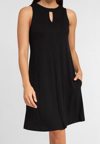 Black sleeveless dress with a round neckline and a small keyhole cutout. Features side pockets and a relaxed A-line silhouette.