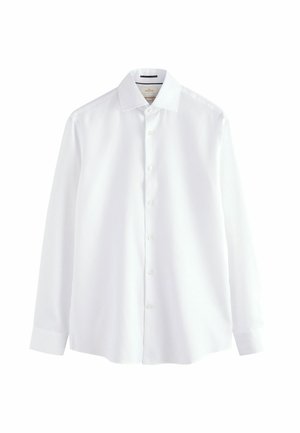 Hosszú ujjú, fehér ing sima pamut anyagból, klasszikus gallérral, gombos elülső részel és egymásra gombolt mandzsettákkal. Nincsenek minták vagy díszítések.