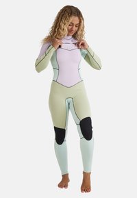 Full wetsuit in light purple and mint green with black knee pads, contoured shape, smooth texture, and flat seams for comfort.