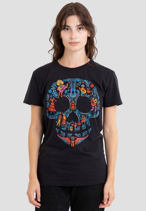 Black cotton t-shirt featuring a colorful skull design with floral patterns and figures, blending vibrant hues of blue, red, yellow, and orange.