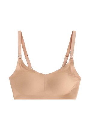 Beige wireless bra with smooth fabric, adjustable straps, and subtle seams. Features a rounded neckline and seamless construction for comfort.