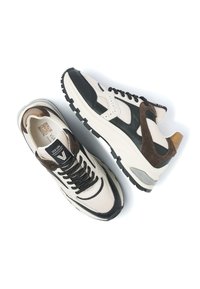 Pair of beige, black, and brown sneakers with mesh and suede textures, black laces, and chunky white soles on a white background.