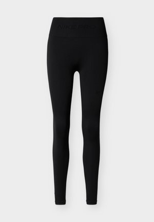 Black Nike Pro leggings with a high waistband. Made from stretchy material, featuring a smooth texture and discreet logo accents. Form-fitting design.
