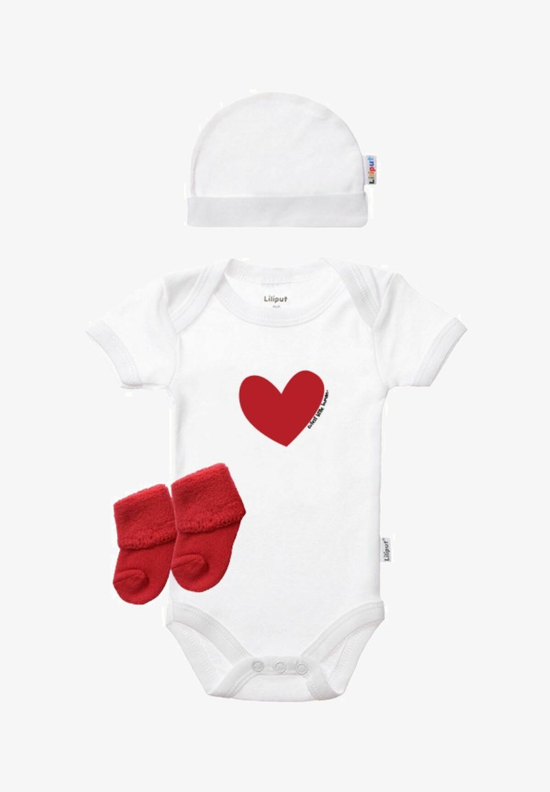 White baby onesie with short sleeves, red heart graphic, accompanied by red fleece booties and a matching white cap. Soft cotton material.