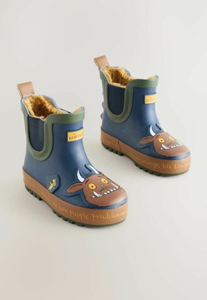 Children's rubber boots in navy with a brown and orange Gruffalo character design, featuring a fuzzy lining, green accents, and textured soles.