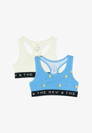 Două sutiene sportive pentru copii, unul crem uni și unul albastru cu imprimeu de lămâi, ambele cu benzi elastice negre inscripționate cu "THE NEV".