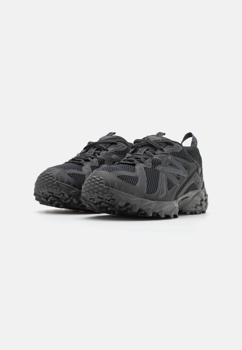Schwarze Sportschuhe verfügen über ein Obermaterial aus Mesh mit strukturierten Akzenten, einer stabilen Gummisohle und einem robusten Profil für besseren Halt.