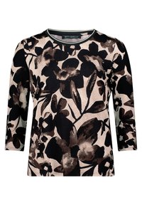 Haut à manches longues à motif floral présentant de grandes fleurs noires et brunes sur un fond clair. Encolure ras du cou avec un bord contrastant. Texture de tissu douce.