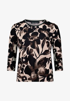 Virágos, hosszú ujjú felső, amelyen nagy fekete és barna virágok találhatók egy világos háttéren. Kerek nyakkivágás, kontrasztos szegéllyel. Puha szövettextúra.